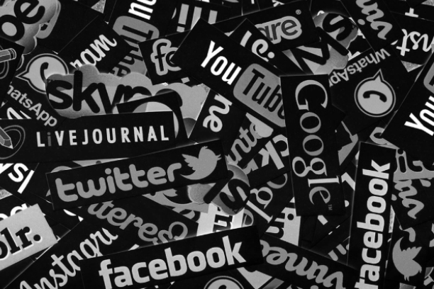 Group of multigenerational people having fun together - Multiracial friends of different ages smiling outdoor - Main focus on african curvy girl face - Black and white editin